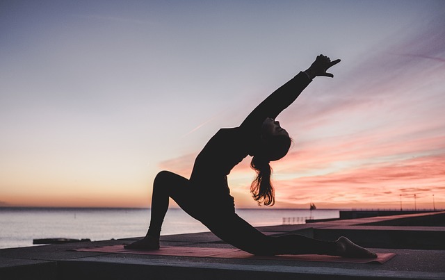 instructor demonstrating gentle stretching technique in bright studio
